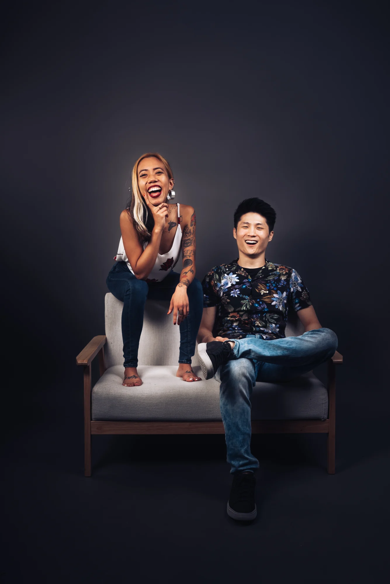 NyaLi and Ze laughing together in a studio portrait