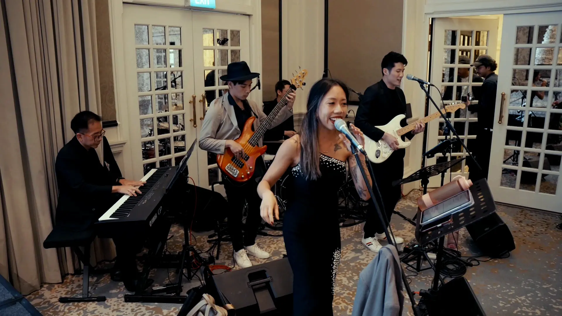 NyaLi singing with the five-piece band on keys, bass, drums and electric guitar
