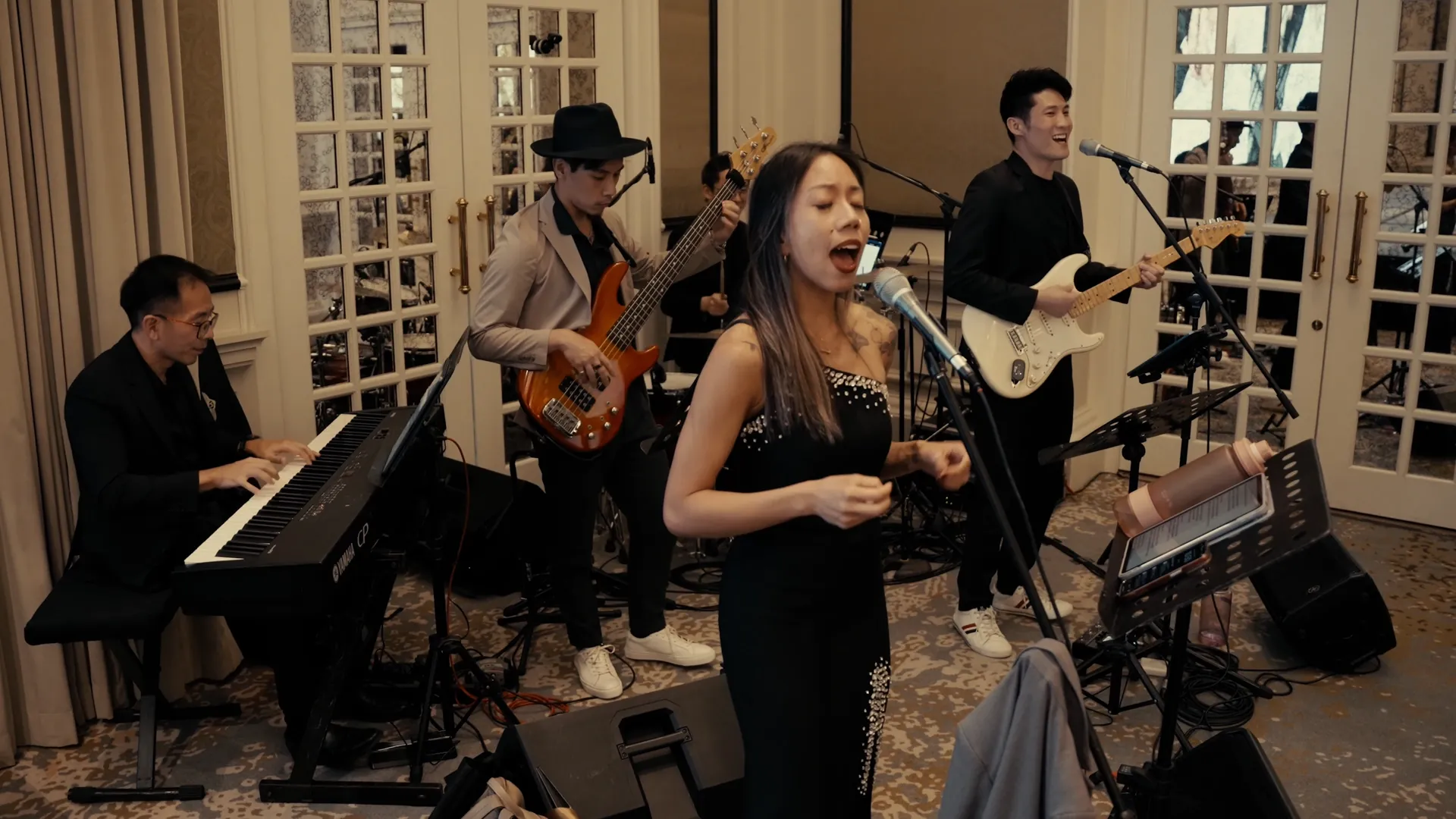 NyaLi singing with the full band on keys, bass, drums and electric guitar